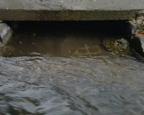 water rushing into a sewer drain