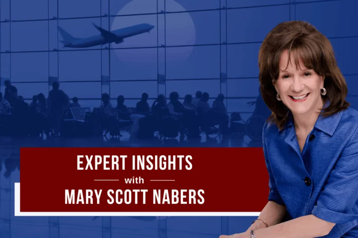 Mary Scott Nabers smiles for a professional headshot in front of a blue graphic of an airport
