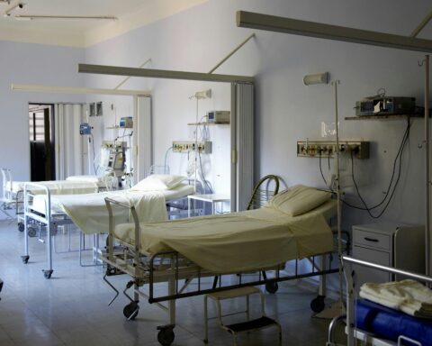 empty hospital beds lined up in a room