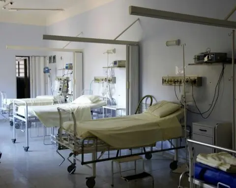 empty hospital beds lined up in a room