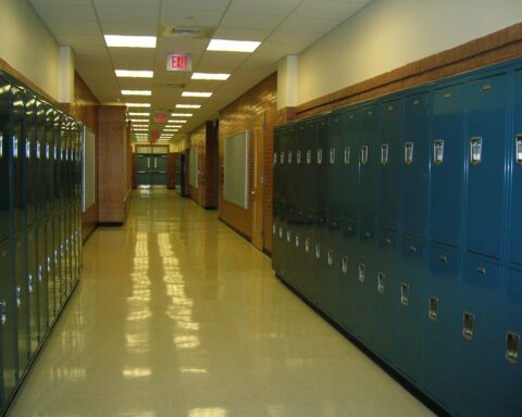 an empty school hallway lined by lockers