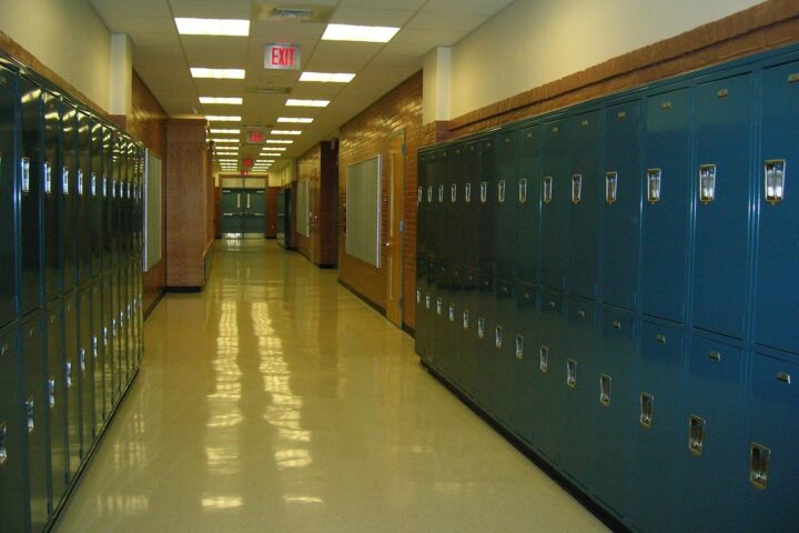 an empty school hallway lined by lockers