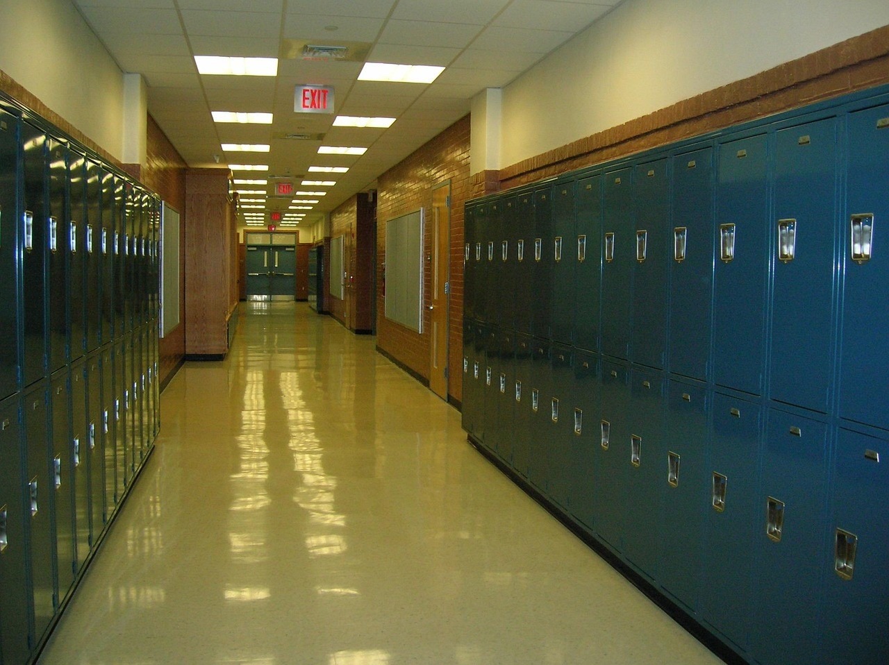 an empty school hallway lined by lockers