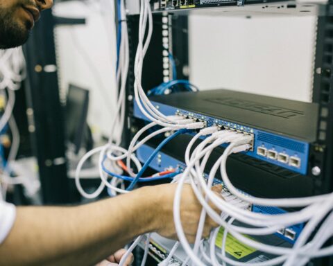 engineer installs cables for broadband internet