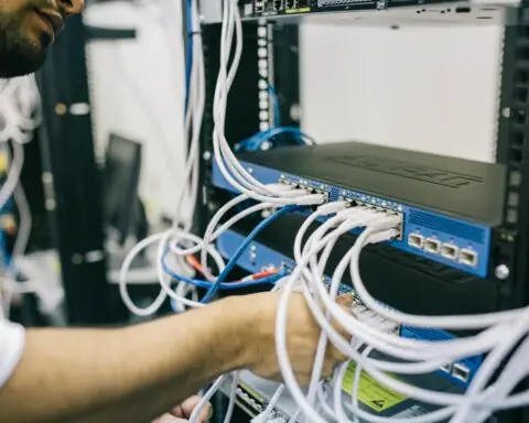 engineer installs cables for broadband internet