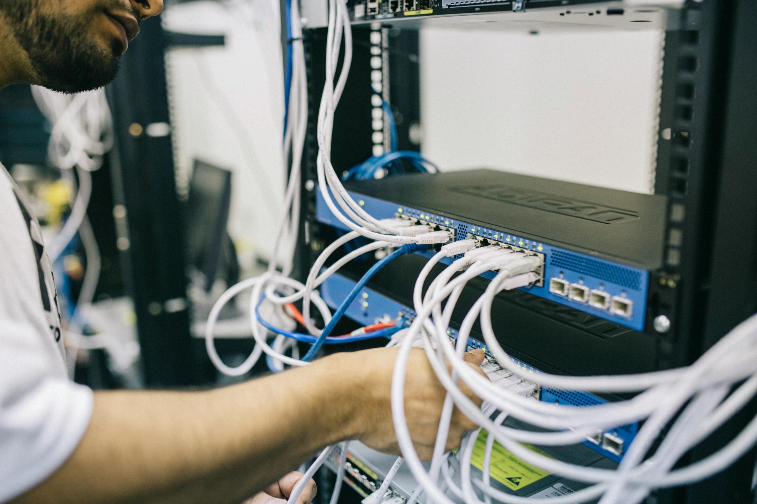 engineer installs cables for broadband internet