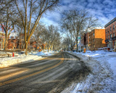 A snow-dusted road is without cars or traffic in a Wisconsin town.