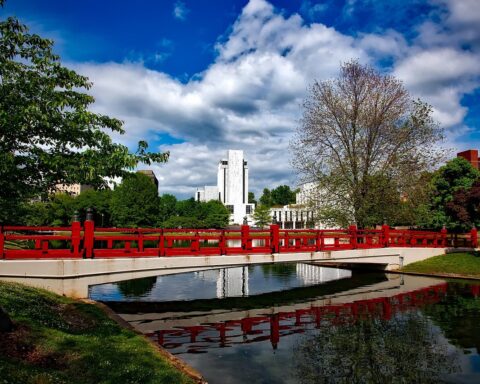 A red bridge sits over a small body of water in Huntsville, Alabama.