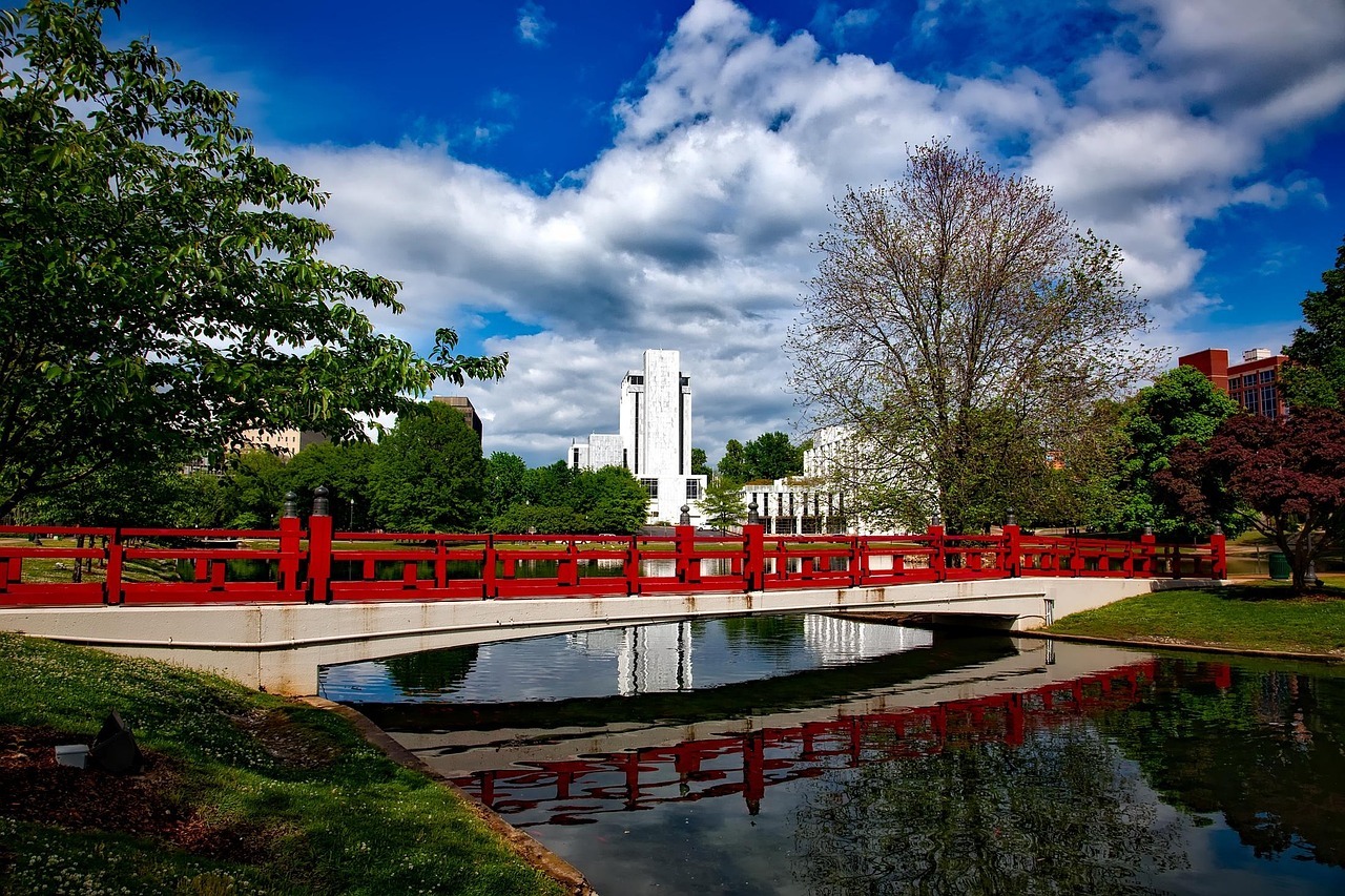 A red bridge sits over a small body of water in Huntsville, Alabama.