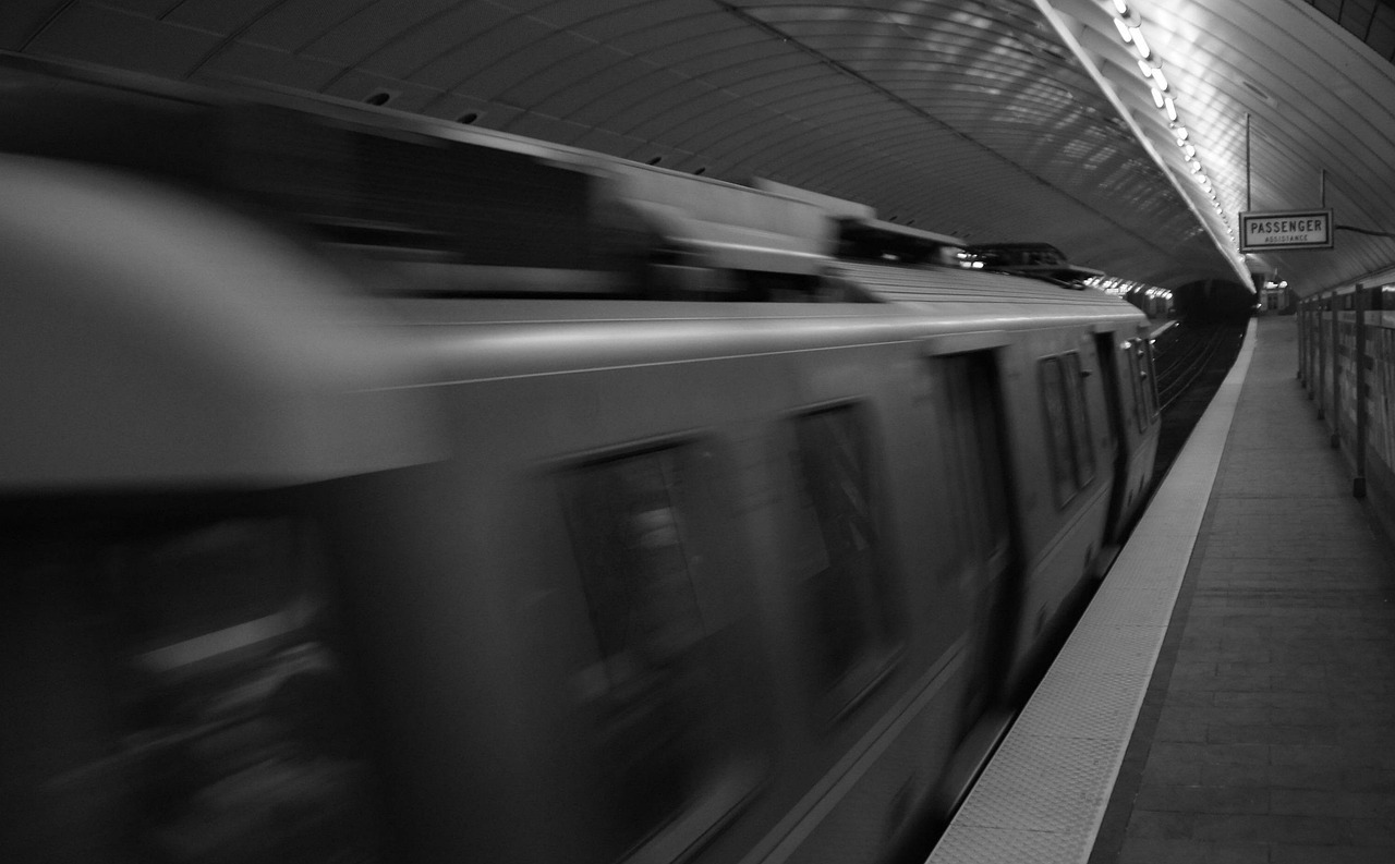 A train in the Massachusetts Bay Transportation Authority system blurs past the platform.