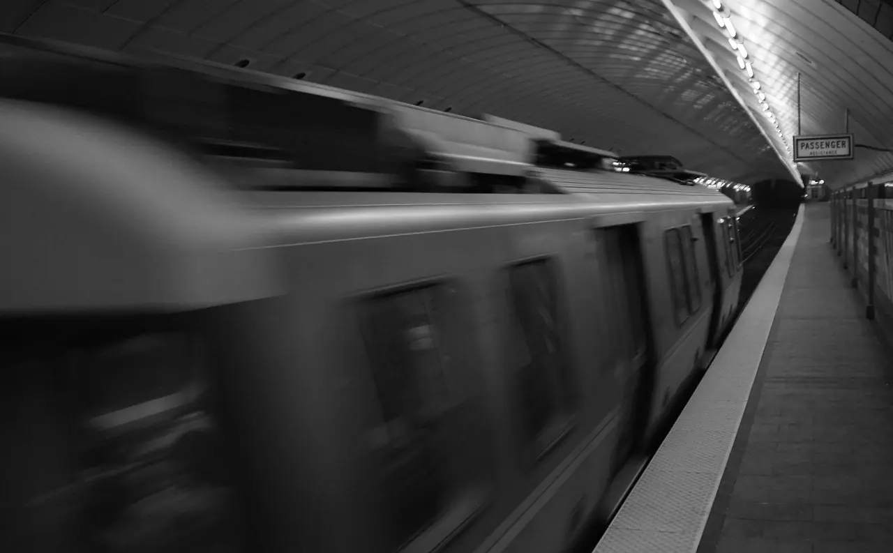 A train in the Massachusetts Bay Transportation Authority system blurs past the platform.