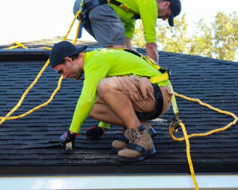 men work on roof repairs