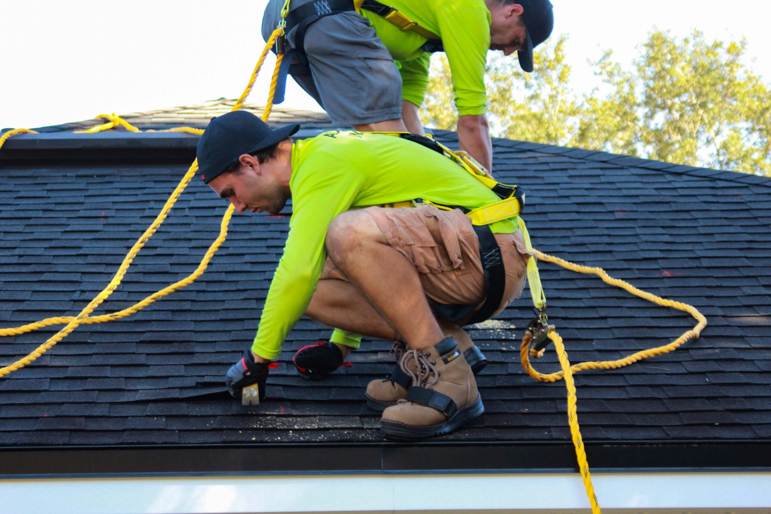 men work on roof repairs