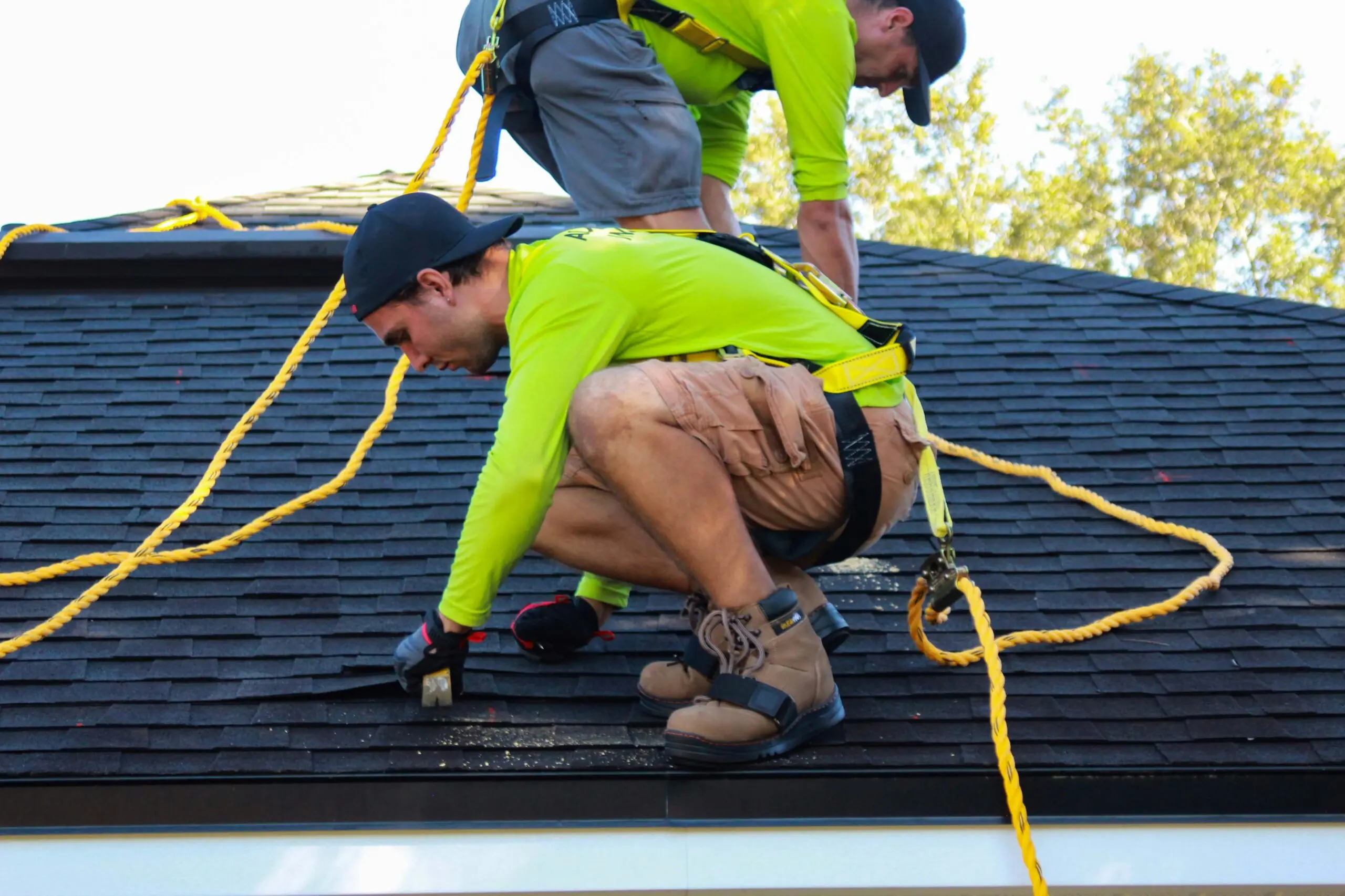 men work on roof repairs