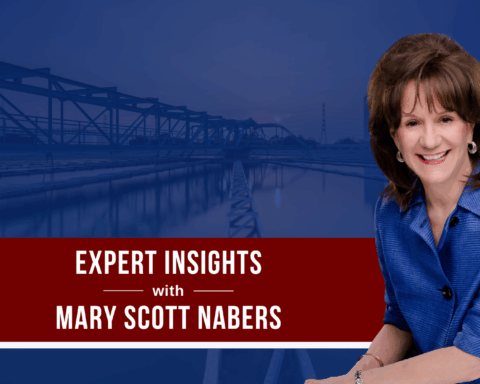Mary Scott Nabers is imposed over a bridge carrying traffic over a body of water.