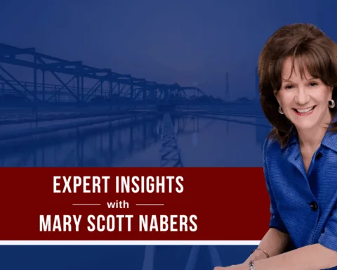 Mary Scott Nabers is imposed over a bridge carrying traffic over a body of water.