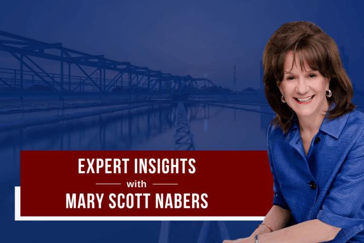 Mary Scott Nabers is imposed over a bridge carrying traffic over a body of water.