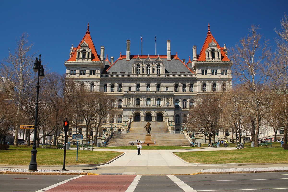 ny capitol building stands against a blue sky