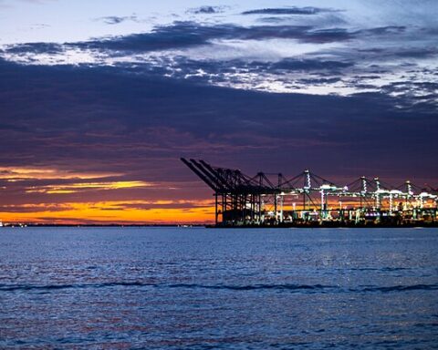 a sunset view of the port of virignia across the ocean