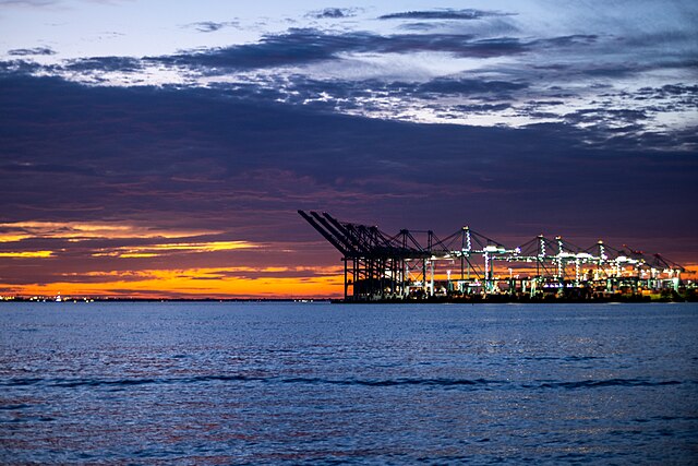 a sunset view of the port of virignia across the ocean