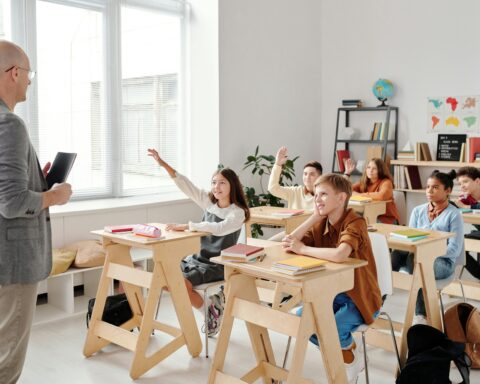 a classroom of engaged students listen to their teacher