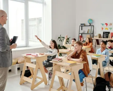a classroom of engaged students listen to their teacher