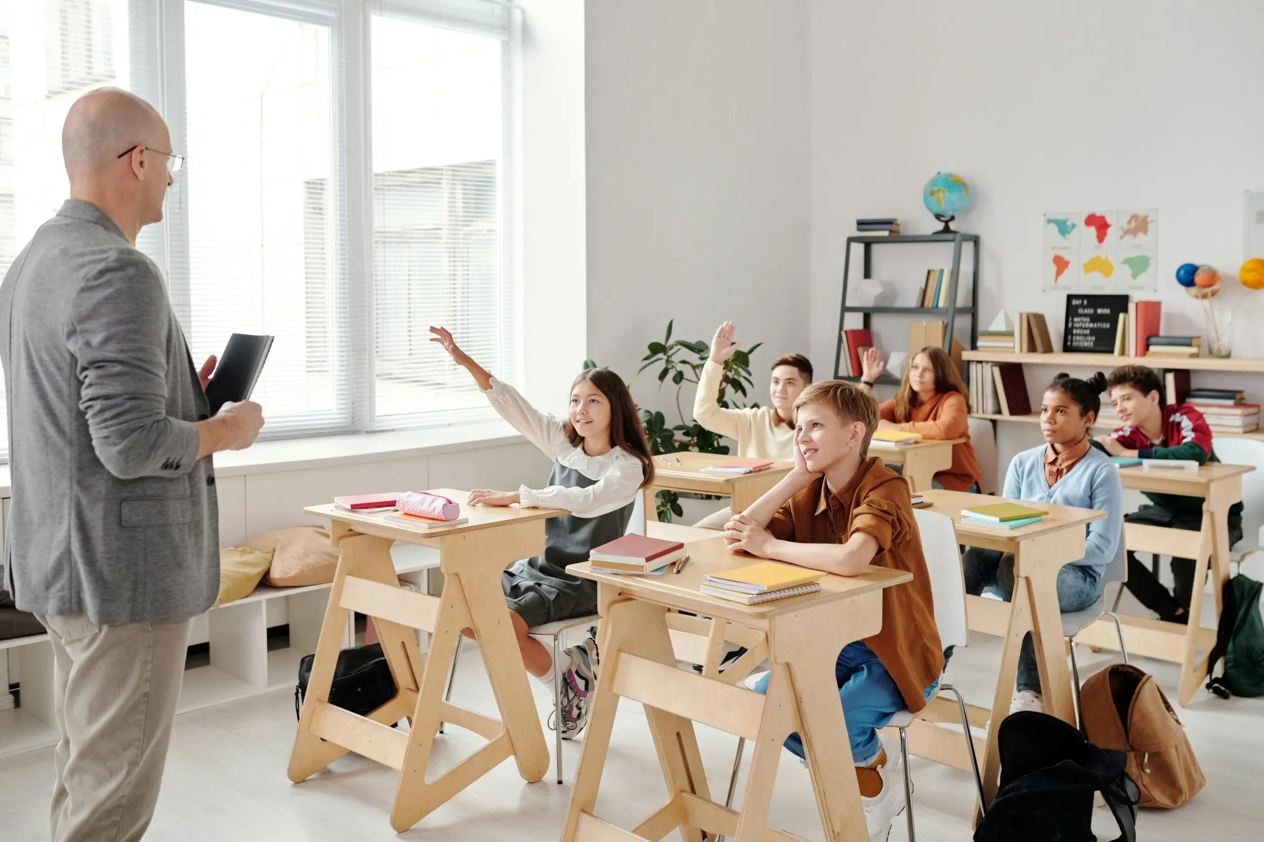 a classroom of engaged students listen to their teacher