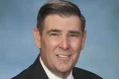 andy gipson smiles for a professional headshot