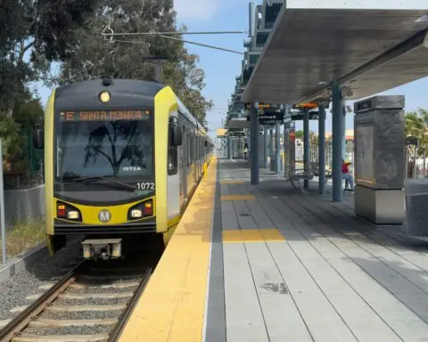 A LA Metro train headed to Santa Monica remains at a passenger platform in California.