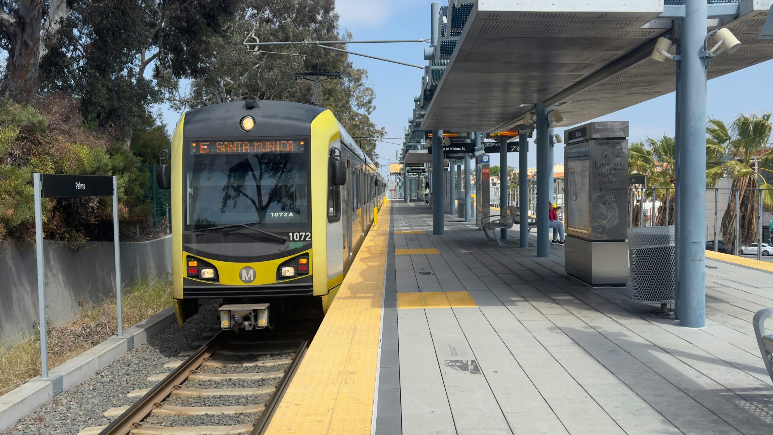 A LA Metro train headed to Santa Monica remains at a passenger platform in California.