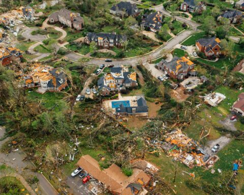 A neighborhood is left ravaged by tornado damage.