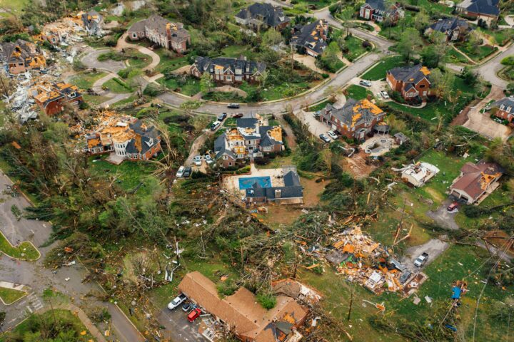A neighborhood is left ravaged by tornado damage.