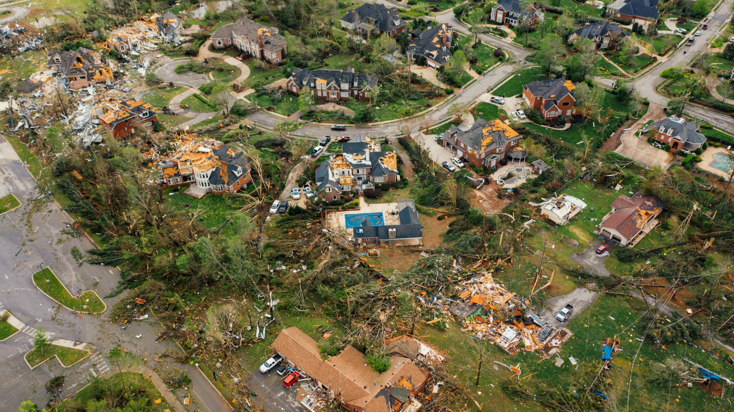 A neighborhood is left ravaged by tornado damage.