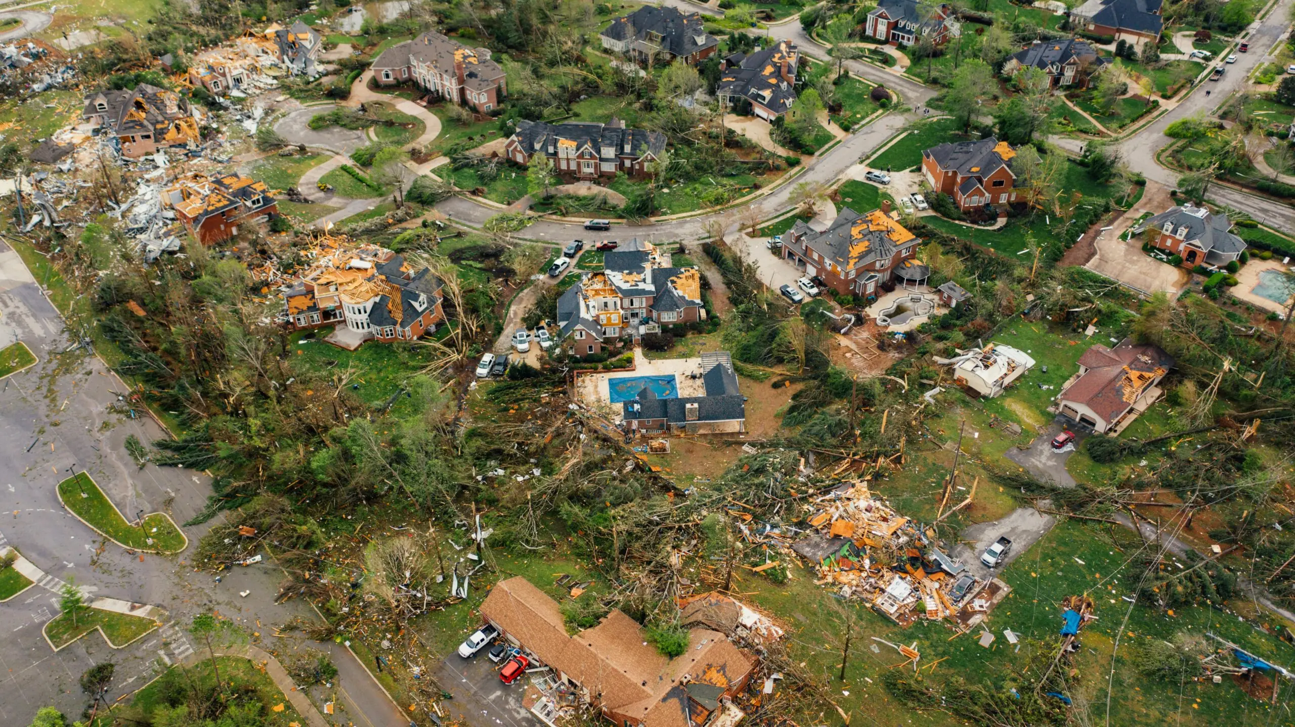 A neighborhood is left ravaged by tornado damage.