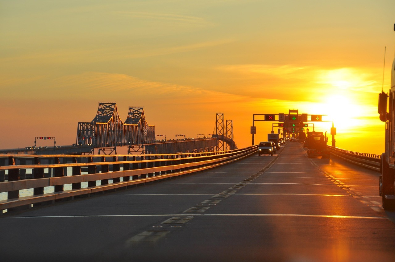 Traffic drives down a long elevated highway as the sun set behind the road in Maryland.