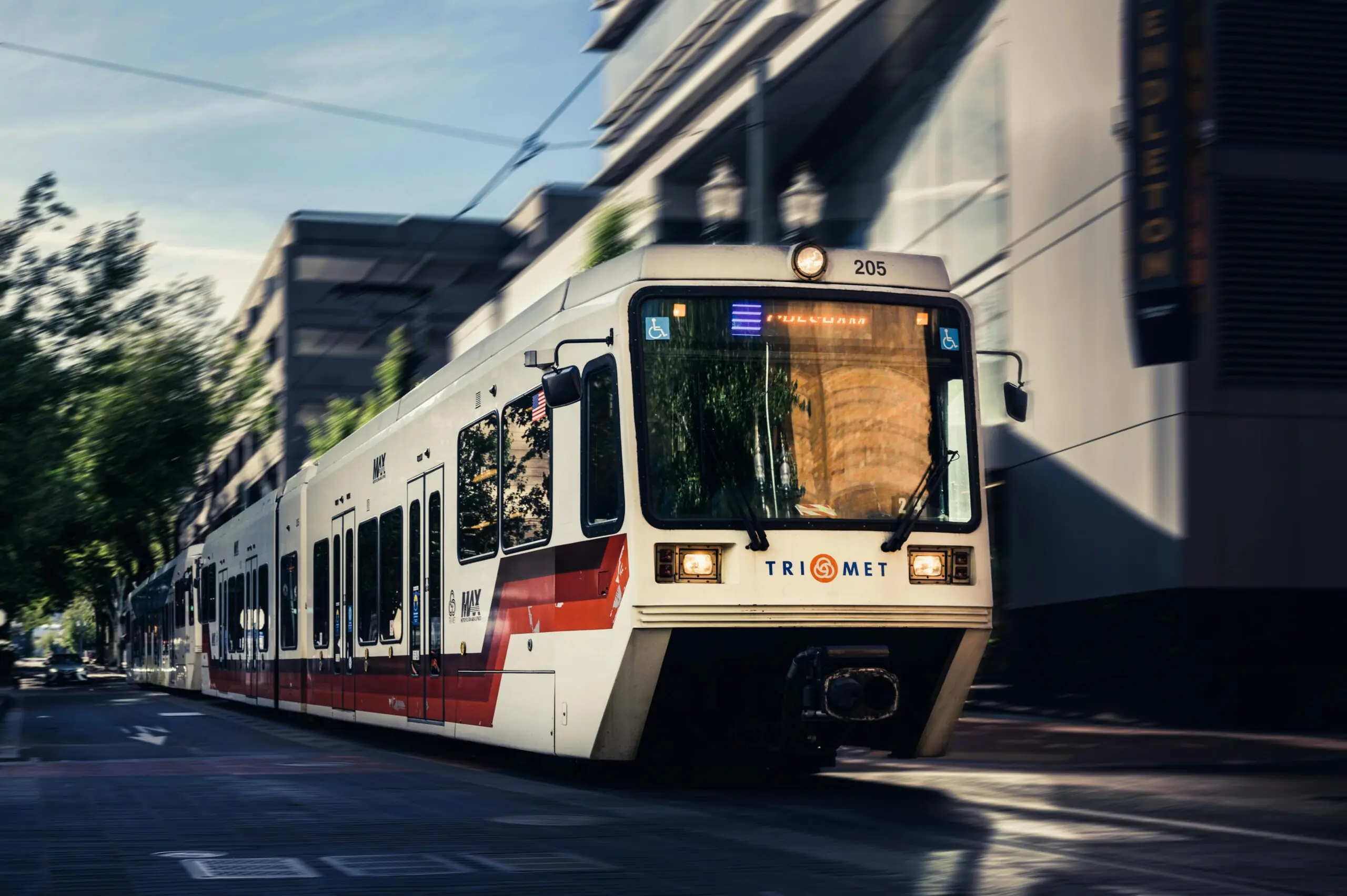 A TriMet train as pictured from the front as it passes in a corridor in Portland, Oregon.