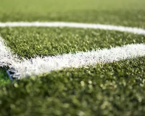 The image depicts the corner stripping of green turf field.