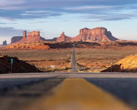 A long highway leads into the desert.