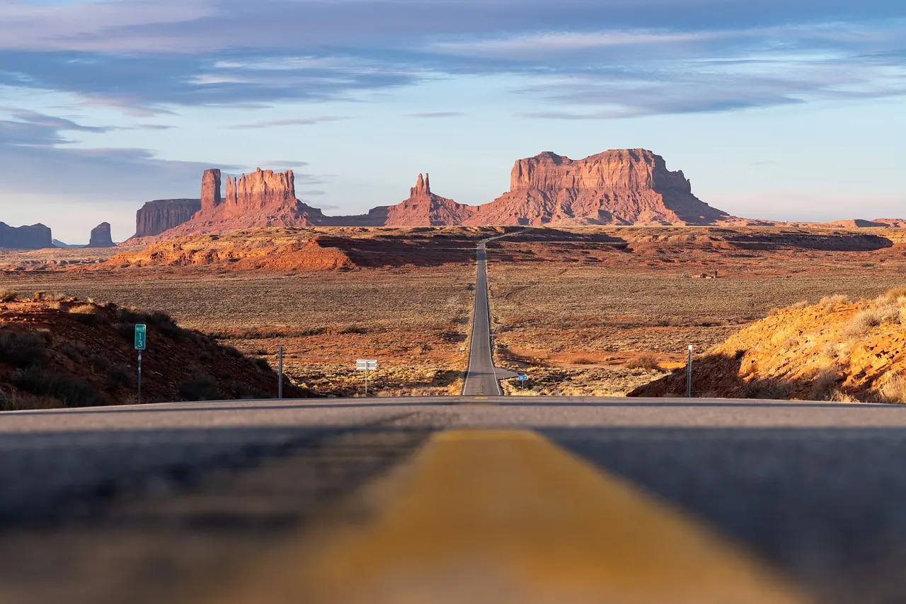 A long highway leads into the desert.