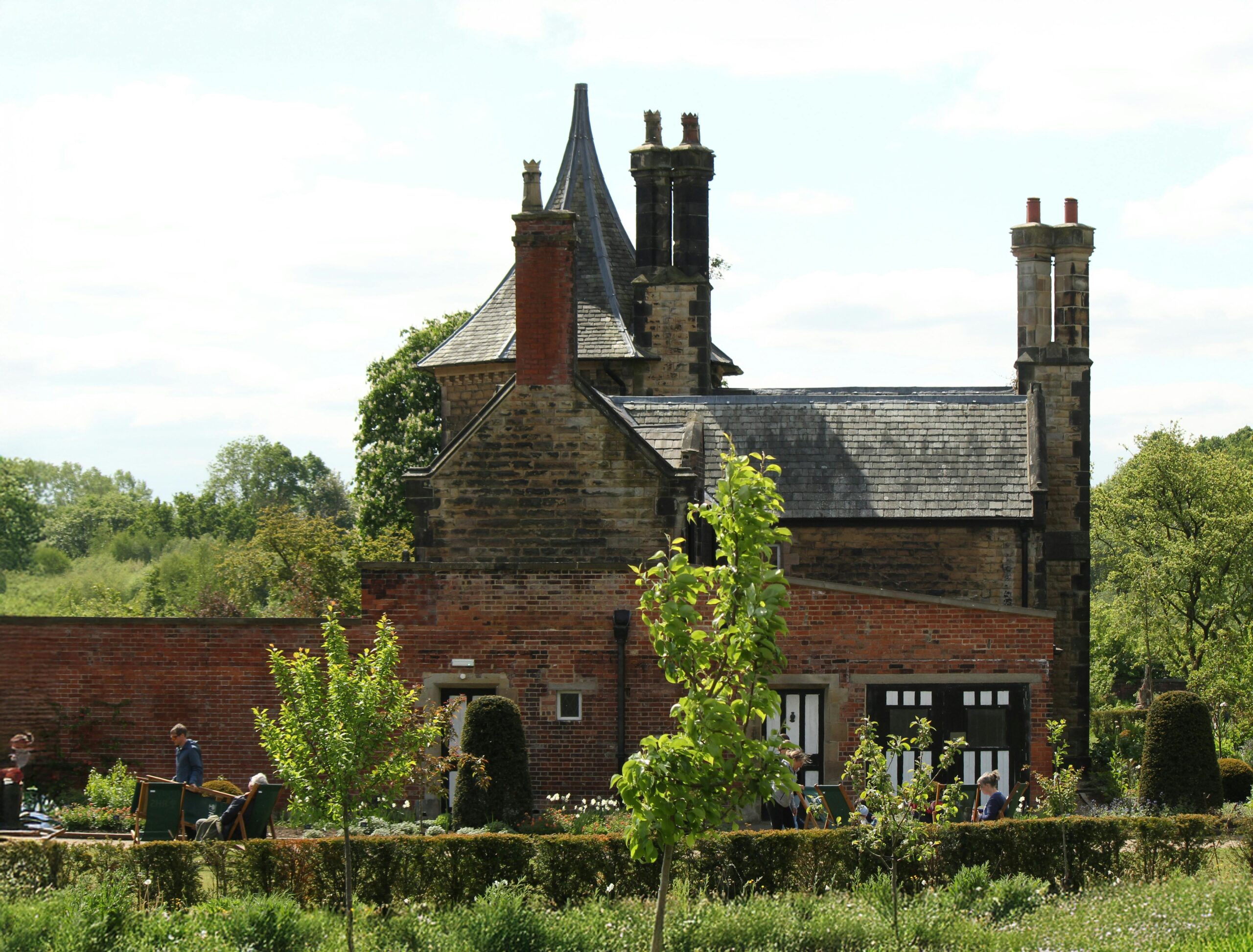 An old, historic building wrapped in greenery and vines.