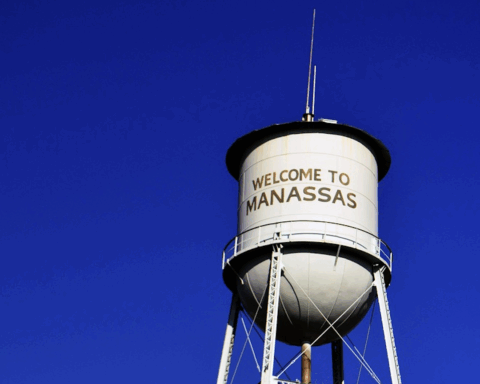 The Manassas Water Tower against a blue sky in Manassas, Virginia.
