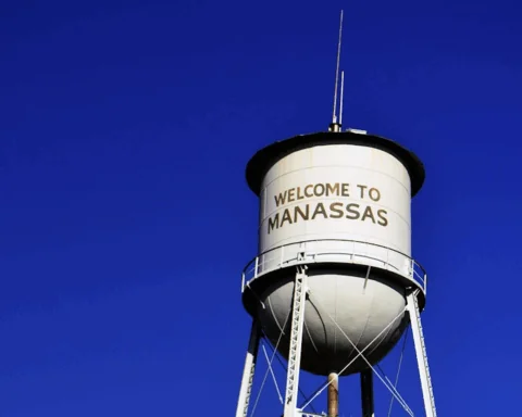 The Manassas Water Tower against a blue sky in Manassas, Virginia.