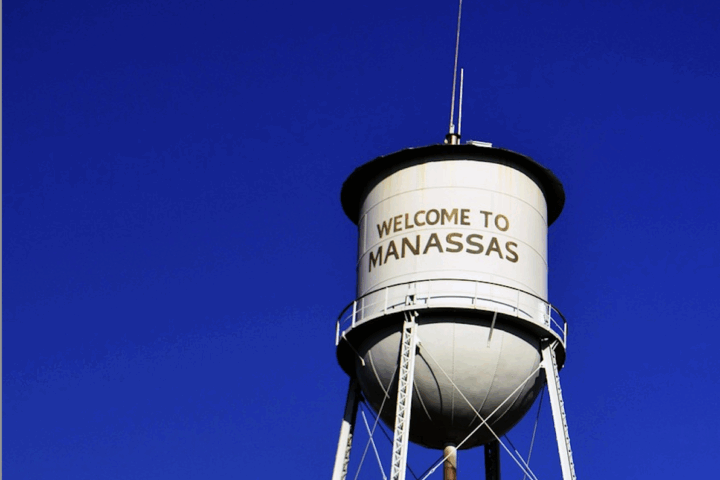 The Manassas Water Tower against a blue sky in Manassas, Virginia.