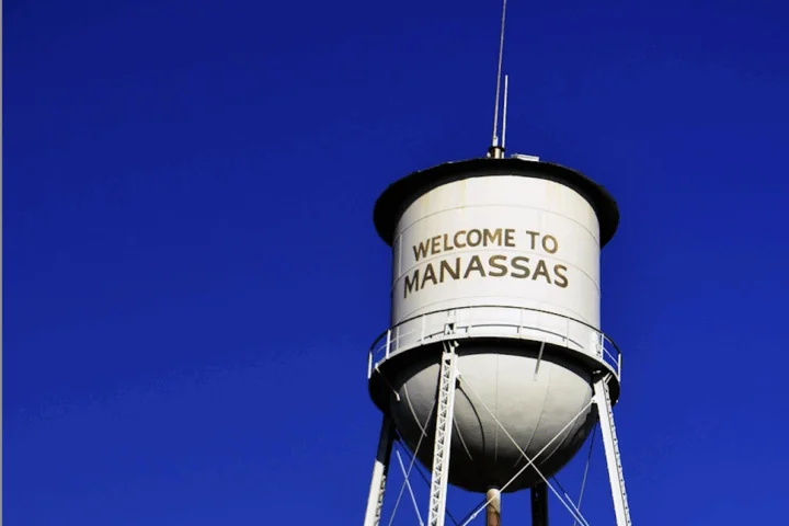 The Manassas Water Tower against a blue sky in Manassas, Virginia.