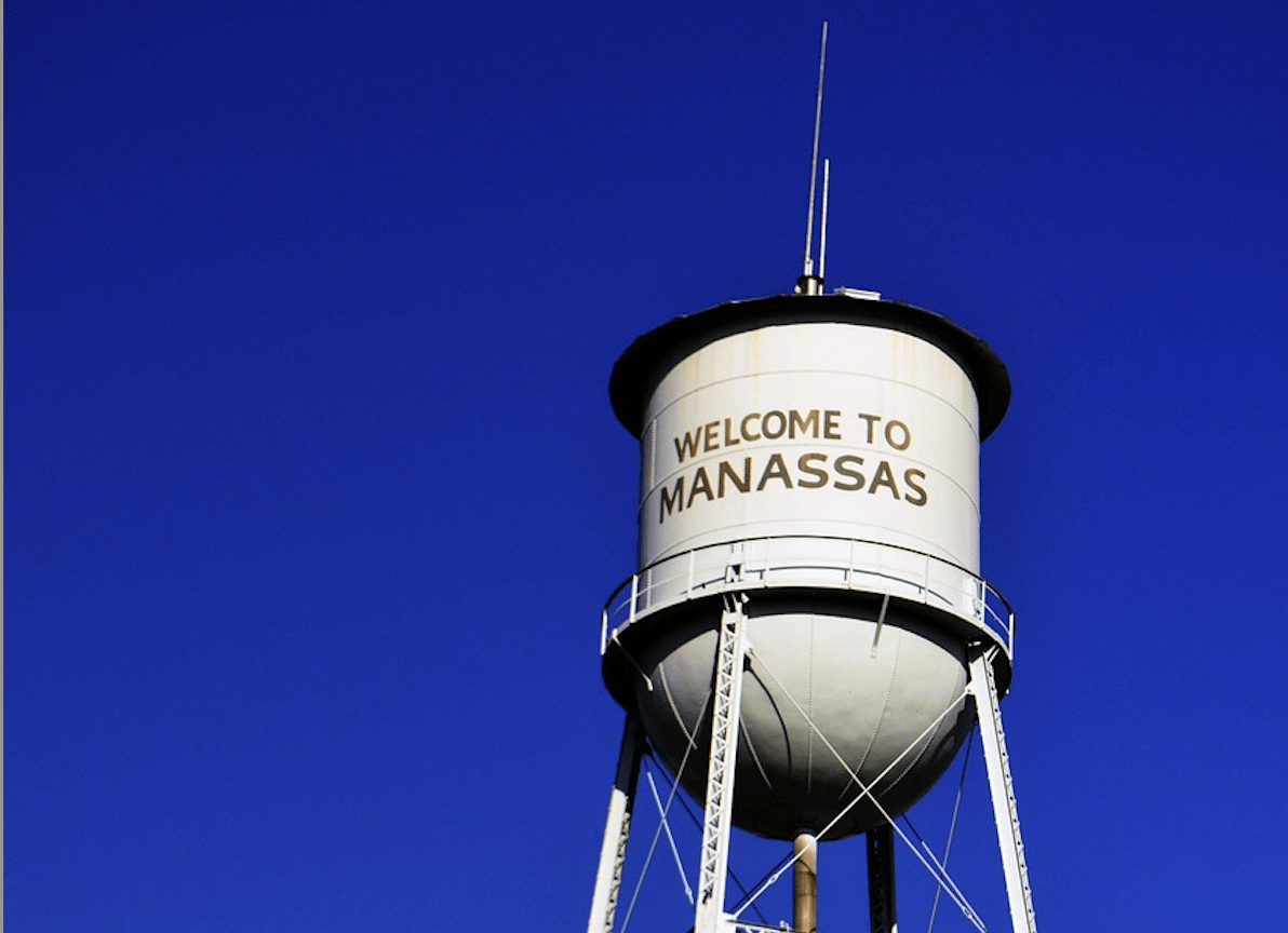 The Manassas Water Tower against a blue sky in Manassas, Virginia.
