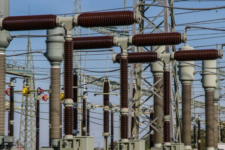 Several energy transformers before a blue sky.