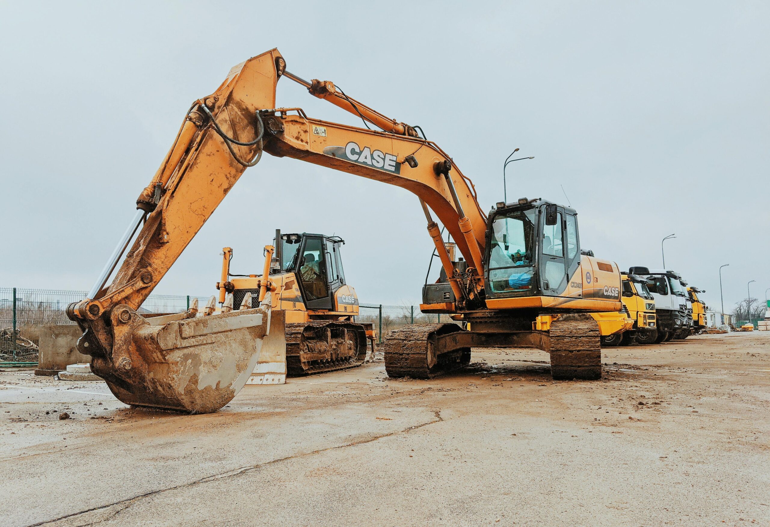 A construction vehicle sits next to another construction vehicle on a job site.
