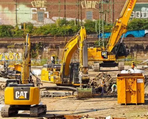 A construction site with construction vehicles, supporting ongoing capital efforts.