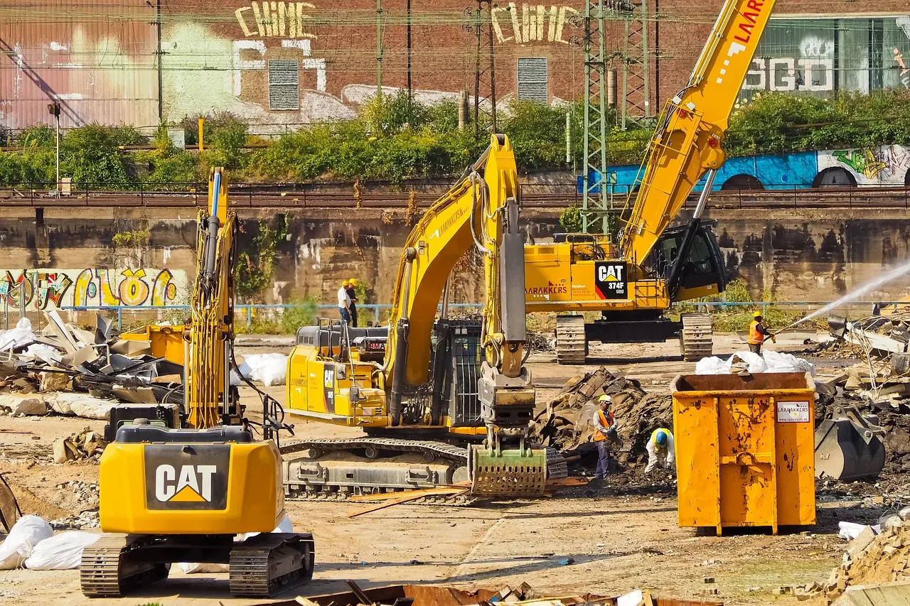 A construction site with construction vehicles, supporting ongoing capital efforts.