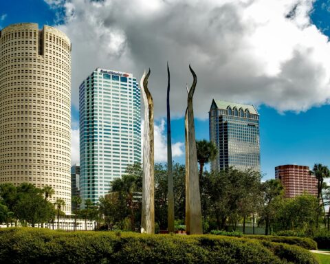 A sculpture in Tamp Bay, Florida stands before skyscrapers.